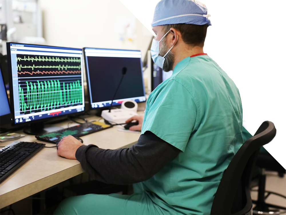 A cardiologist checking a computer