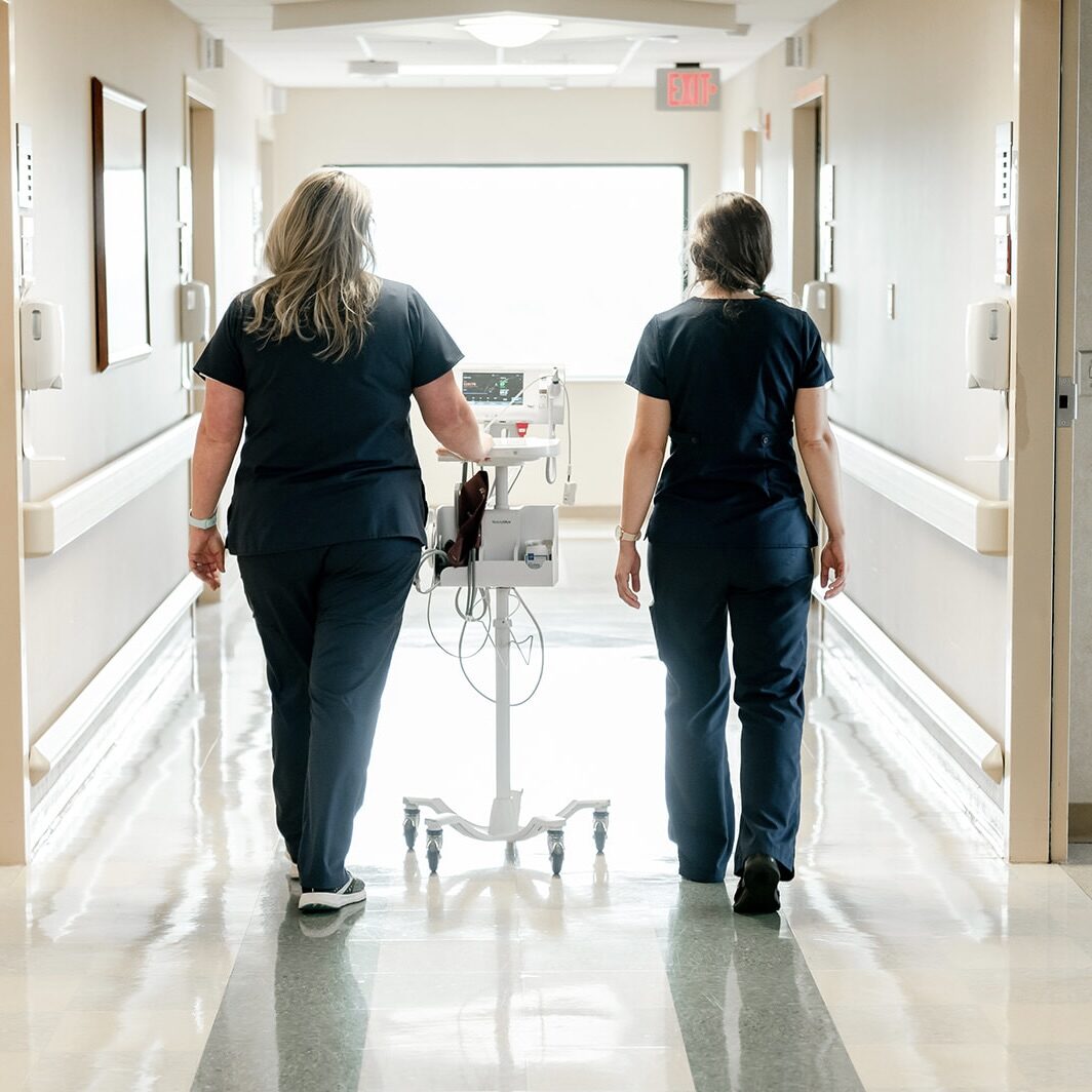 Nurse and student walking